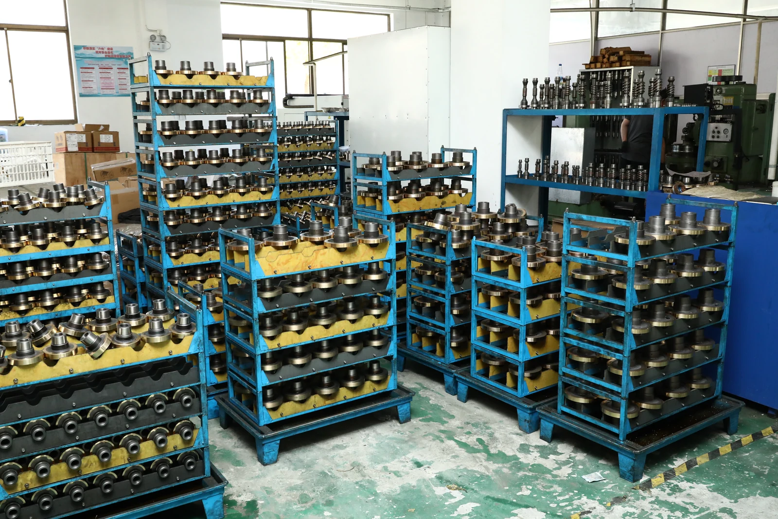 Worm gear and shaft components organized between production stages at the SMK factory